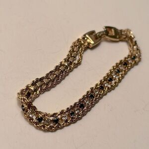 Gold Tone Rope Bracelet with Bezel set dark blue and clear stones